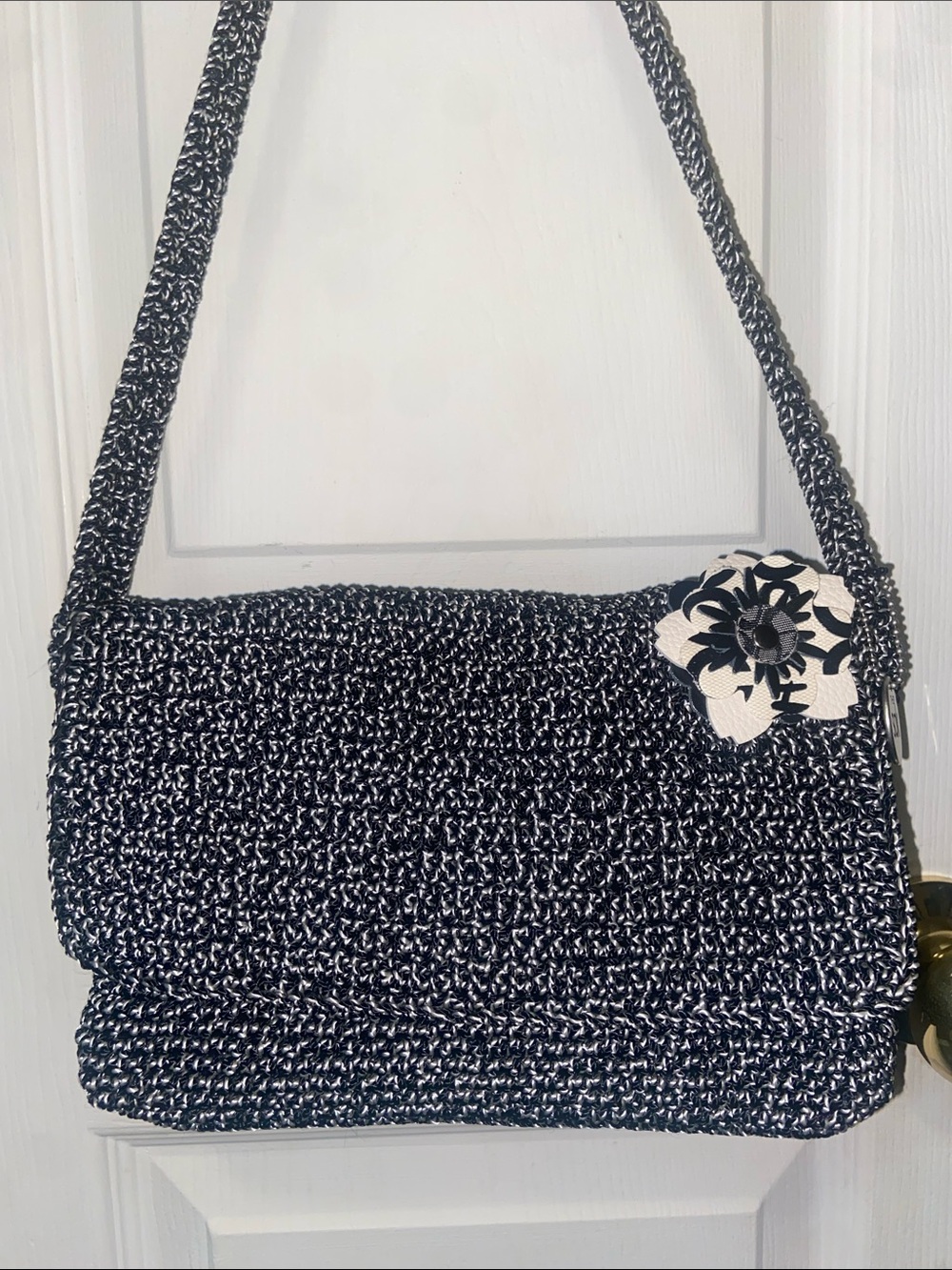 The Sak Black and White Flap Shoulder Bag with Leather Flower Charm